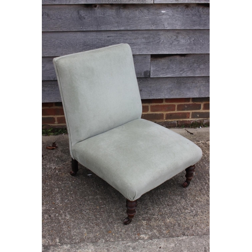 570 - A late 19th century low seat nursing chair, upholstered in a sage green velour, on turned and castor... 