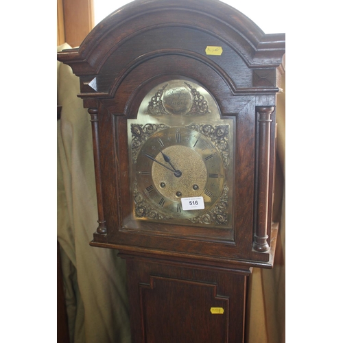 599 - An oak long case clock with arch top brass dial and striking and chiming movement, 63