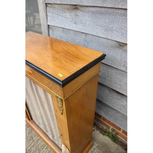 542 - A late 19th century walnut inlaid and brass bound pier cabinet enclosed single glazed door, on block... 