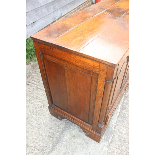 543 - An 18th century oak mule chest, now converted as a cupboard, fitted two drawers, on bracket feet, 55... 