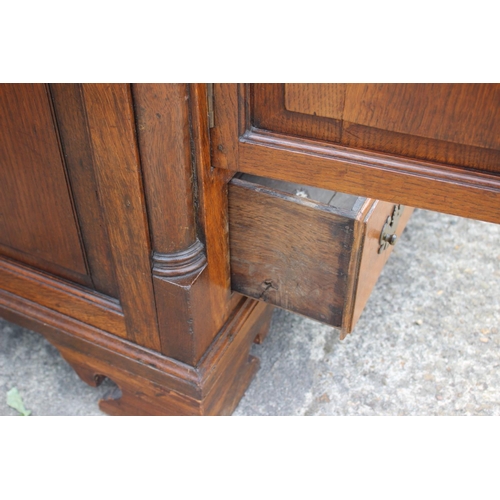 543 - An 18th century oak mule chest, now converted as a cupboard, fitted two drawers, on bracket feet, 55... 