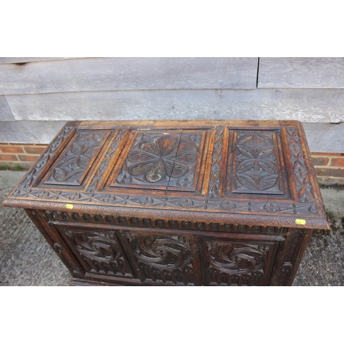 553 - A chip carved oak coffer of 16th century design with three Gothic panel front, on stile supports, 39... 