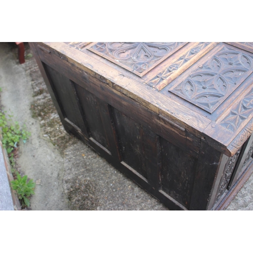 553 - A chip carved oak coffer of 16th century design with three Gothic panel front, on stile supports, 39... 