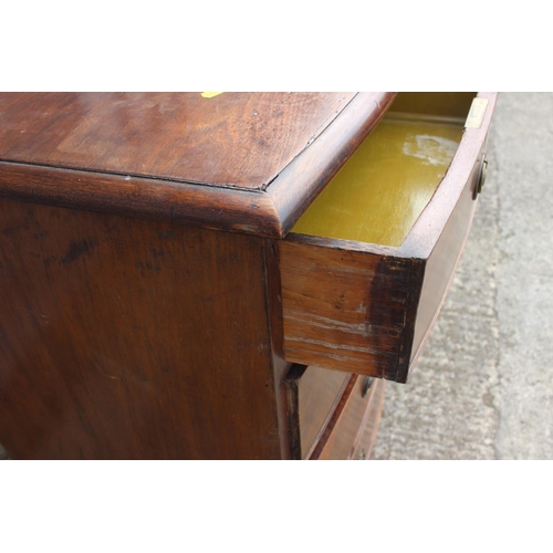 555 - A 19th century mahogany bowfront chest of two short and three long graduated drawers with brass ring... 