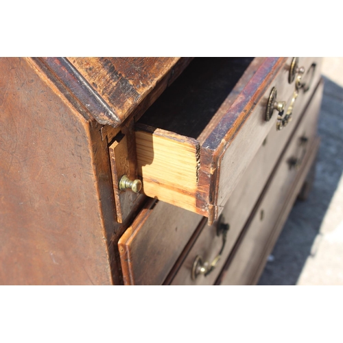 561 - A Georgian mahogany bureau with fitted interior over four long graduated drawers, on bracket support... 