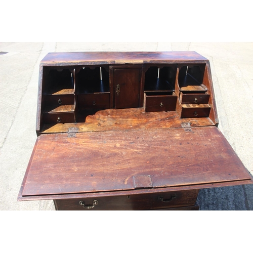 561 - A Georgian mahogany bureau with fitted interior over four long graduated drawers, on bracket support... 