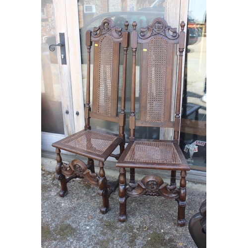 563 - A pair of 19th century carved oak high back chairs, in the manner of Daniell Marot, on shaped suppor... 