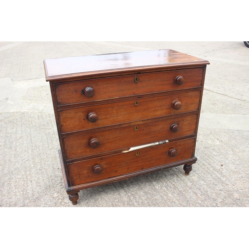 564 - A 19th century mahogany chest of four long graduated drawers with knob handles, on turned supports, ... 