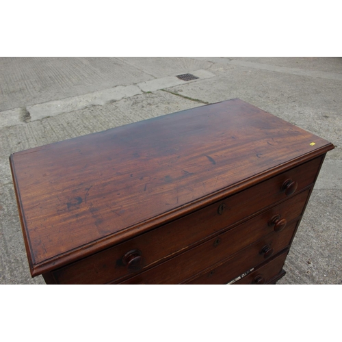 564 - A 19th century mahogany chest of four long graduated drawers with knob handles, on turned supports, ... 