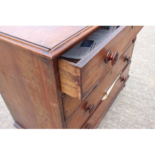 564 - A 19th century mahogany chest of four long graduated drawers with knob handles, on turned supports, ... 