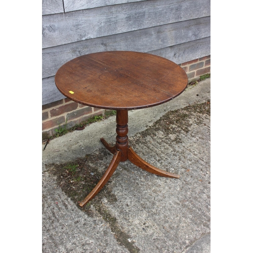 569 - A 19th century provincial mahogany circular tilt top occasional table, on tripod splay supports, 24