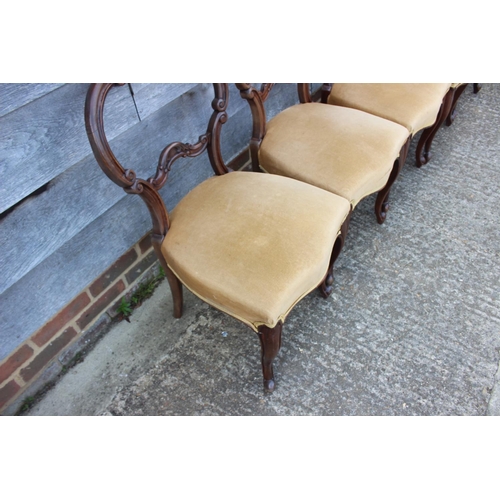 575 - A set of six mid Victorian carved walnut balloon back dining chairs with stuffed over seats, on cabr... 