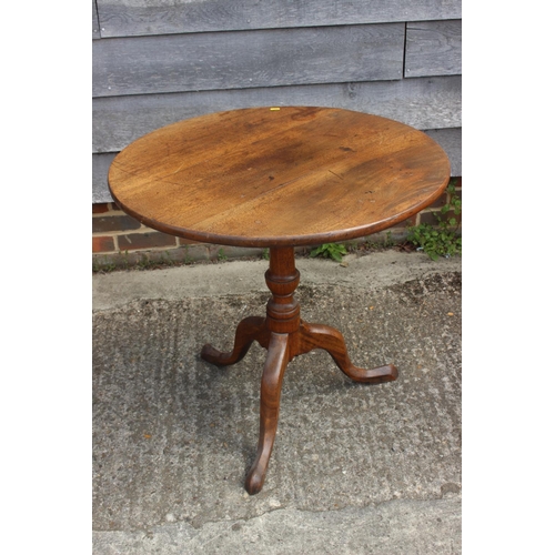 581 - A 19th century mahogany circular tilt top occasional table, on vase turned column and tripod splay s... 