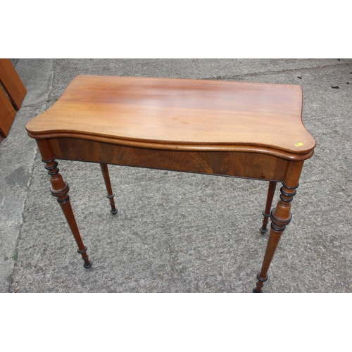 584 - A late 19th century Scandinavian fold-over top serpentine front tea table, on ebonised banded slende... 