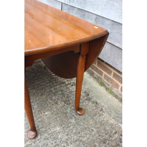 590 - A walnut deep drop leaf dining table of Georgian design, on pad feet, 64