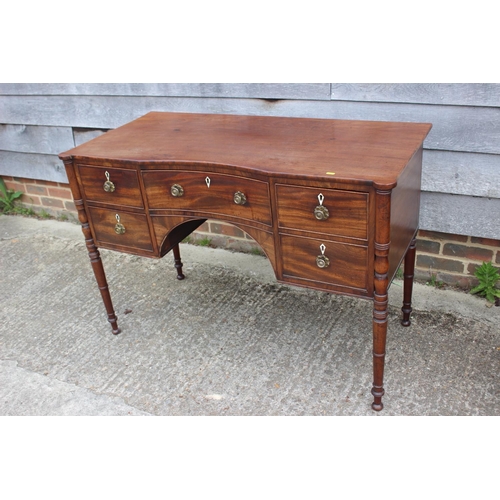 591 - A George III mahogany inverse breakfront sideboard/dressing table, fitted five drawers with brass li... 