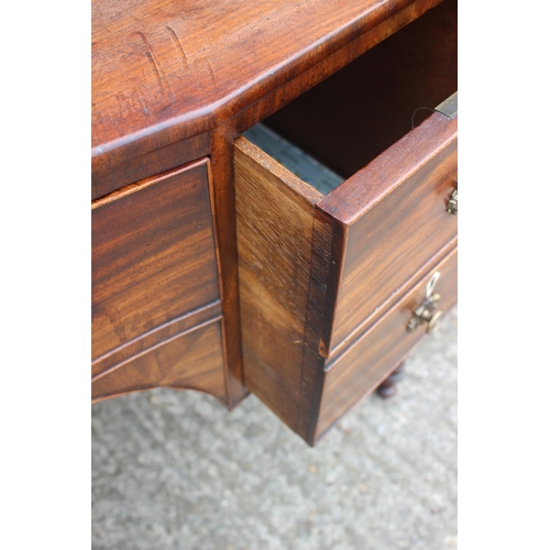 591 - A George III mahogany inverse breakfront sideboard/dressing table, fitted five drawers with brass li... 