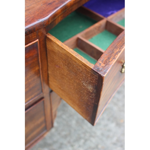 591 - A George III mahogany inverse breakfront sideboard/dressing table, fitted five drawers with brass li... 