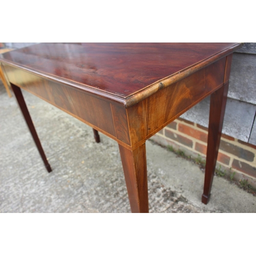 592 - A Georgian mahogany fold-over top tea table, on kingwood banded square taper supports, 36