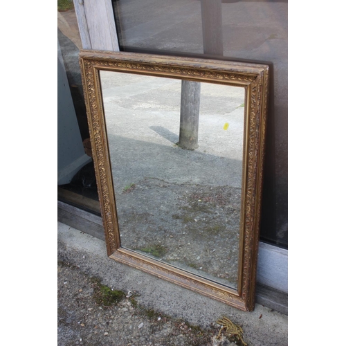 606 - An early 20th century gilt framed wall mirror, plate 21