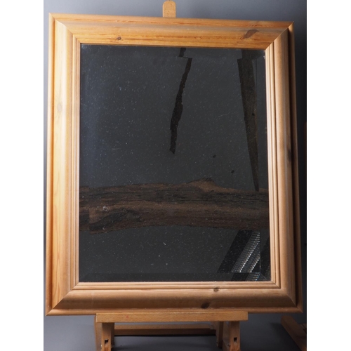 607 - A waxed pine framed wall mirror with bevelled plate, 16