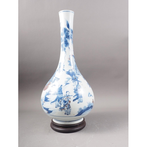 108 - A Chinese blue, white and iron oxide bulbous bottle neck vase with figures in a landscape decoration... 