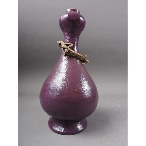 113 - A Chinese purple glazed bulbous vase with relief dragon decoration, 9 1/2