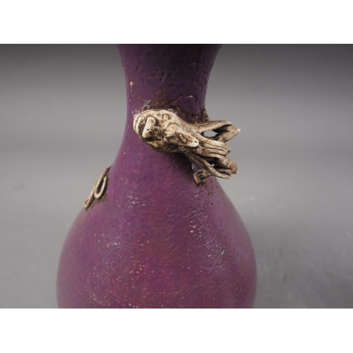 113 - A Chinese purple glazed bulbous vase with relief dragon decoration, 9 1/2