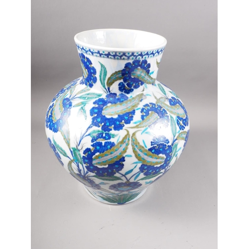 15 - An Isnik bulbous vase of traditional floral design in shades of blue, 15