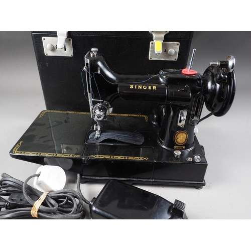 159 - A model 222k Singer sewing machine, in travelling case with accessories