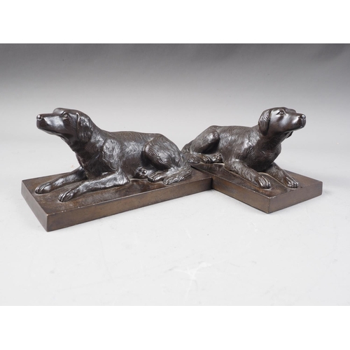 162 - A pair of bronze model reclining gun dogs, on rectangular bases, 8