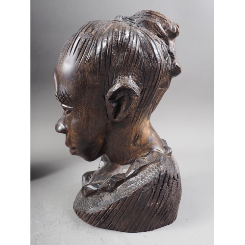 179 - An African carved ebony bust, a similar shallow relief bust, and a jar and cover, formed as a figure... 