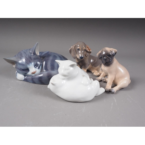 19 - A Royal Copenhagen model of a sleeping cat (057), a Copenhagen model of two cats (unmarked), a pug p... 