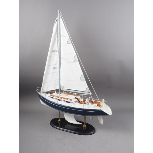 218 - A scale model sailing yacht, on oval ebonised stand, 26