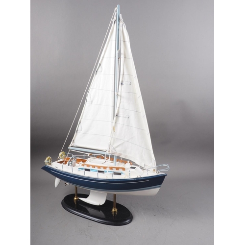 218 - A scale model sailing yacht, on oval ebonised stand, 26