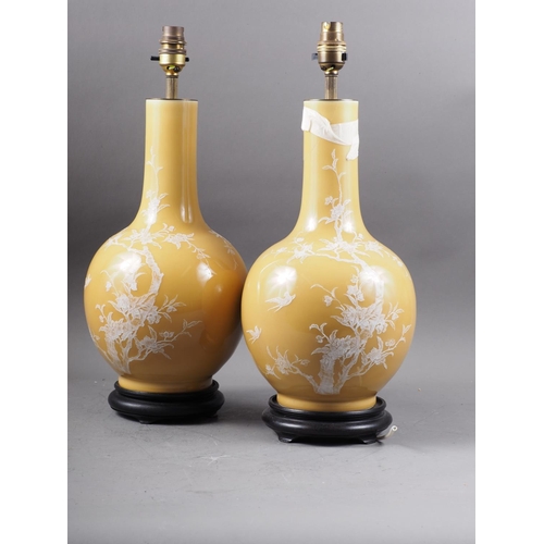 253 - A pair of Chinese bulbous bottle neck table lamps with pate-sur-pate tree, flower and bird decoratio... 