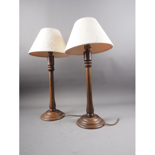 260 - A pair of turned oak table lamps, on circular bases, 16 1/4