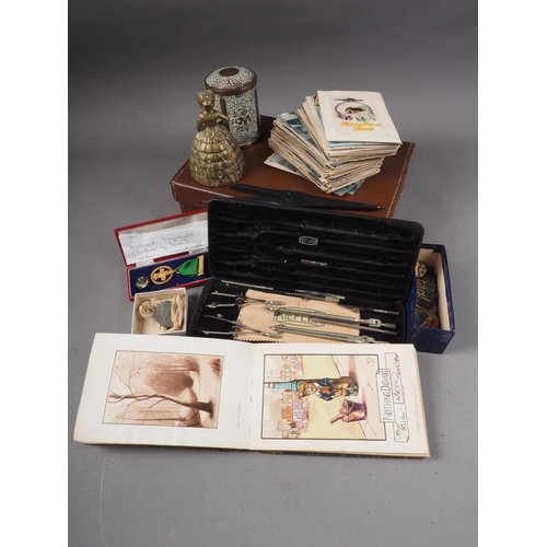 265 - A quantity of early 19th century postcards, an autograph album, various medals and other items