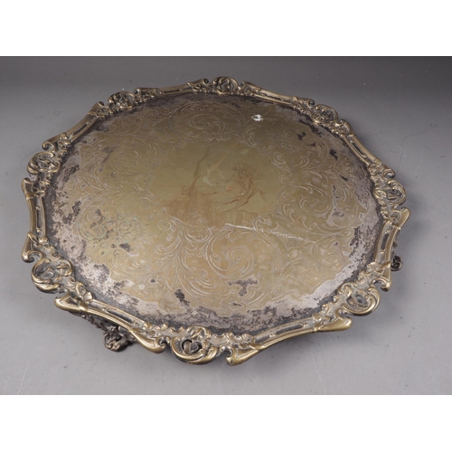 277 - A silver plated pie crust salver, raised on four scrolled supports, 17