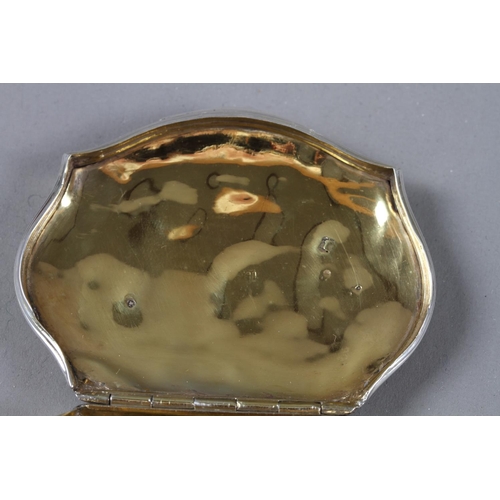 290 - An early 19th century Continental silver snuffbox with embossed decoration and gilt interior