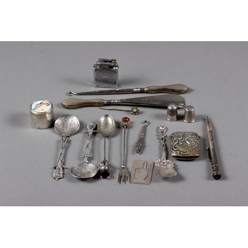 315 - A group of silver and white metal items, including spoons, thimbles, manicure implements, a Polo lif... 