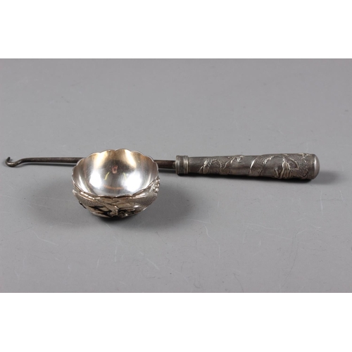 316 - A Japanese silver miniature bowl, decorated koi carp, and a Chinese silver-handled button hook with ... 