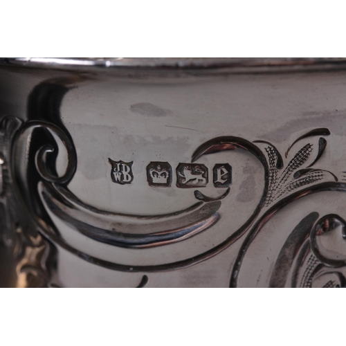 321 - A silver teapot with embossed decoration and ebonised handle and knop, and a silver sauce boat, 9.3o... 