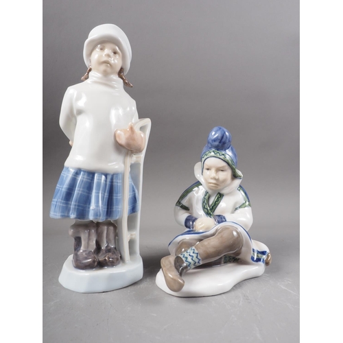 33 - Two Royal Copenhagen figures, girl with sled (1382) and Greenland girl (1398)