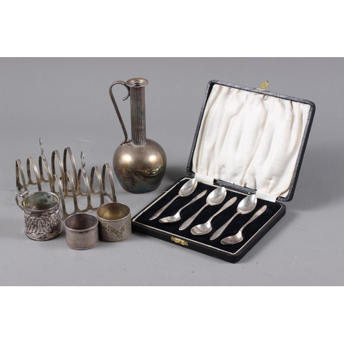 343 - A set of six silver teaspoons, in case, two silver toast racks, a Danish silver napkin ring, another... 