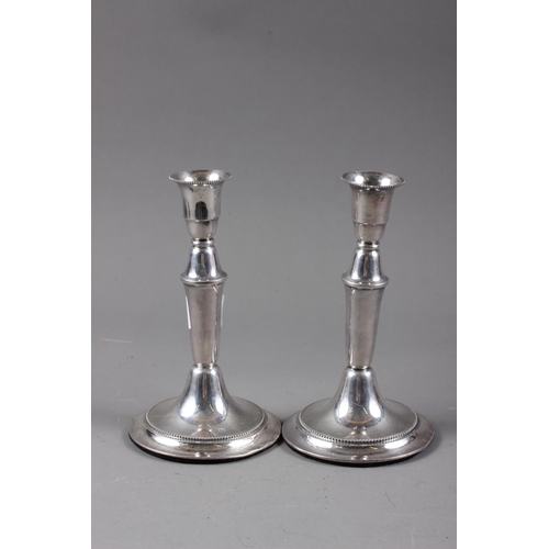 345 - A pair of silver candlesticks, on circular bases, 6 3/4