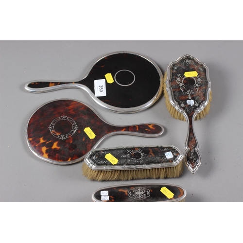 350 - Two tortoiseshell and silver backed dressing table mirrors, and three similar brushes