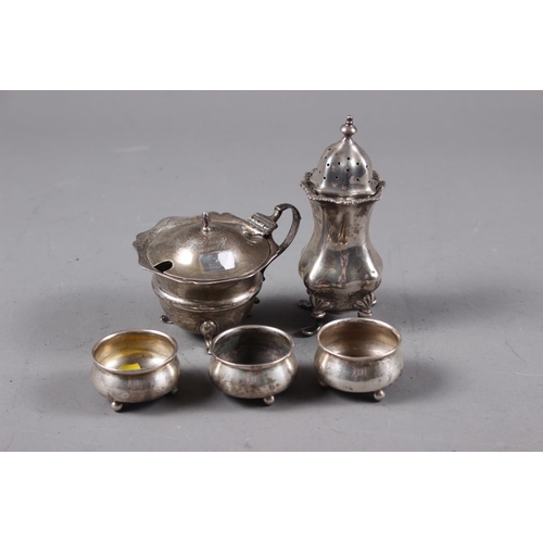 355 - A set of three silver salt cellars, on three bun feet, a silver mustard pot and a similar pepper pot... 