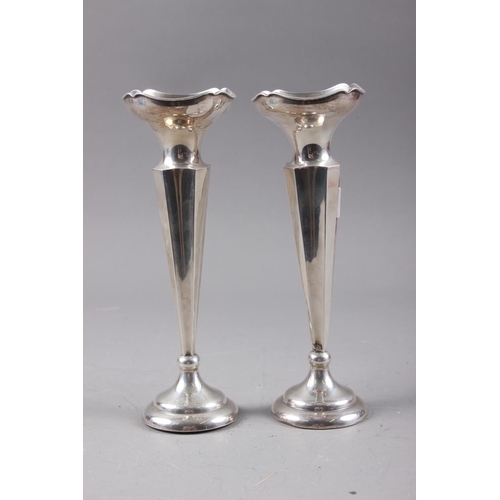 358 - A pair of filled silver shaped column vases, on circular bases, 9