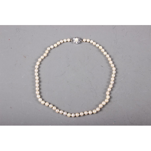 406 - A pearl single-strand necklace, clasp stamped 18k